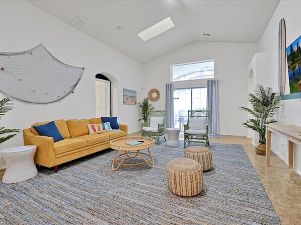 Spacious and cozy living room with plush seating and TV