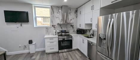 Sleek, modern kitchen with everything you need, including filtered water on tap! Whip up a culinary masterpiece with ease. From stainless steel appliances to ample counter space, cooking here is a joy
