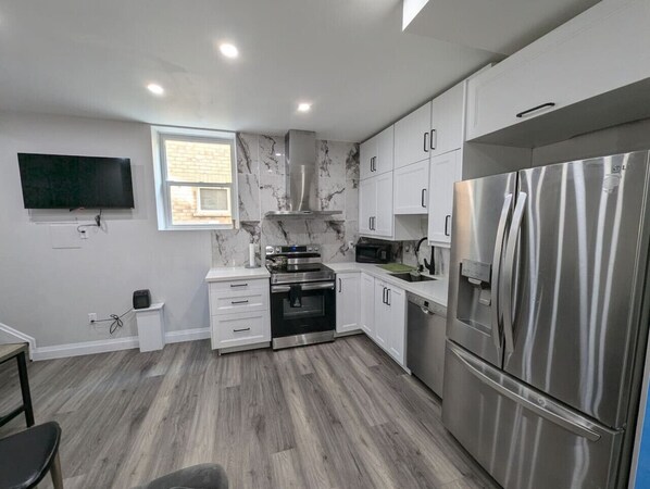 Sleek, modern kitchen with everything you need, including filtered water on tap! Whip up a culinary masterpiece with ease.  From stainless steel appliances to ample counter space, cooking here is a joy