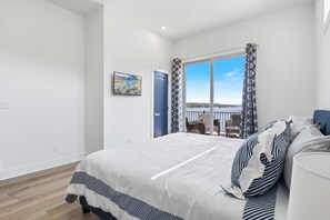 Wake up to stunning lake views in this bright and airy bedroom with direct access to a private balcony, perfect for enjoying your morning coffee.