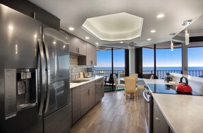 Fully equipped kitchen featuring stainless steel appliances and stunning ocean views. Cook and dine in luxury at this Myrtle Beach retreat