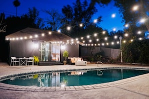 Guest house view at night with pool