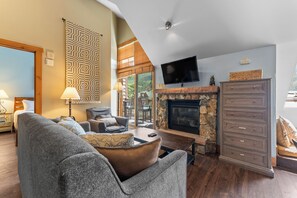 Living area with vaulted ceilings and flatscreen TV