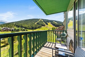 Private balcony with outdoor seating, up-close golf course views in the summer and slope views in the winter.