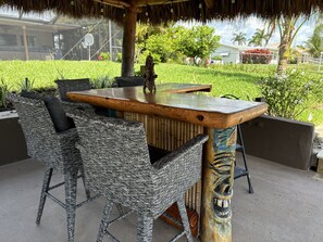 Tiki Hut with TV on Canal, bar top with seats for 5.  