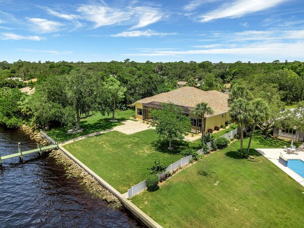 This spectacular backyard oasis features an outdoor swimming pool, beautiful landscaping, a 220-foot dock, and waterfront access!