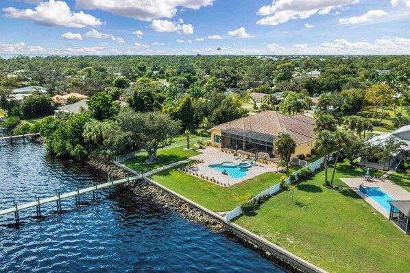 This spectacular backyard oasis features an outdoor swimming pool, beautiful landscaping, a 220-foot dock, and waterfront access!