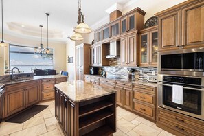 Featuring an oversized kitchen island, ample counter space, and top-of-the-line appliances, this kitchen is the gold standard for kitchens! 