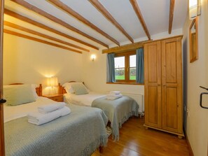 Comfortable and cosy twin single beds with garden views. 
