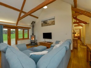 Vaulted ceiling living space with deep comfortable sofas. 