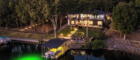 Relax in luxury at this stunning lakefront retreat, offering a private dock, breathtaking waterfront views, and serene evenings illuminated by soft lights. Perfect for your peaceful getaway!