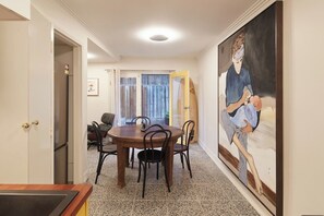 Artworks surround you as you wine and dine at this stylish deep timber table in the dining area. 