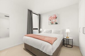 The plush bedroom comes with a queen-sized bed, set with side table and reading lights, and comes with large wardrobes for your belongings.
