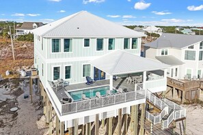 Sea Bliss | Luxurious Beachfront Retreat | Heated Pool | Located on the Pristine Fort Morgan Beaches of Gulf Shores, Alabama | Spacious Home with Two Living Rooms for Ample Gathering Space | Elevator for Easy Access Across All Levels