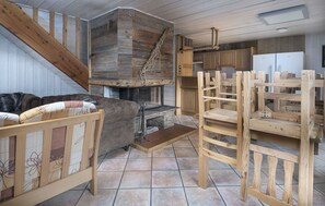 Open-concept living and dining area with a wood stove, creating a warm and inviting atmosphere.