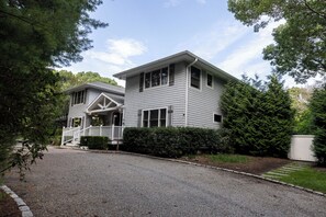 Drive up to this beauty with a large circular driveway and so many mature trees