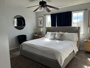 Primary en suite bedroom with double sink bathroom. Mounted tv on wall.
