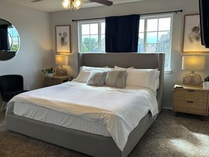 Primary en suite bedroom with double sink bathroom. Mounted tv on wall.