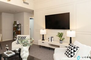 Enjoy a movie night or catch up on your favorite shows with the large flat-screen TV in this beautifully furnished living space.