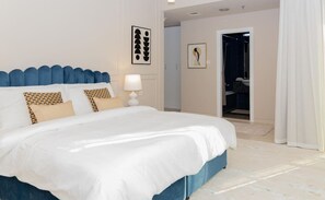 Drift into restful sleep in the luxurious bedroom with a king-size bed, soft linens, and elegant decor, offering ultimate comfort.