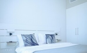 Experience ultimate comfort in this spacious bedroom featuring a cozy king-size bed and soft linens.