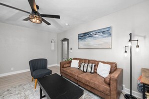Walk in to the newly renovated living area featuring: plush 3-seater couch, remote fan control, Smart TV with live cable, books, board games and more!