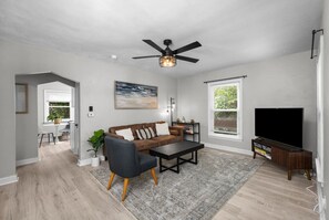 Walk in to the newly renovated living area featuring: plush 3-seater couch, remote fan control, Smart TV with live cable, books, board games and more!