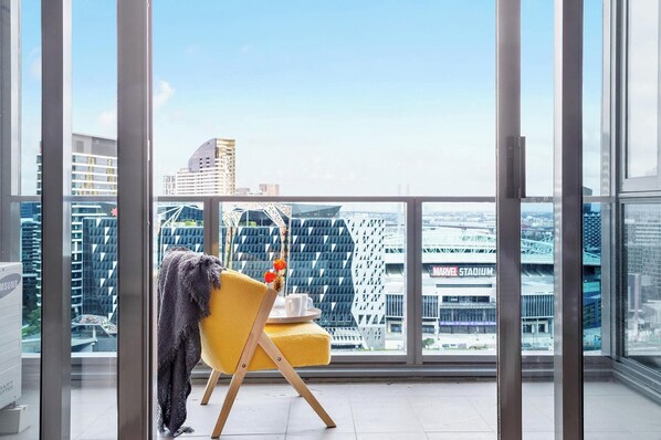 A balcony with a view over Docklands Harbour. *(Chair is from living room).