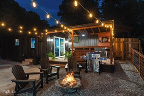 Enjoy nighttime grilling and a cozy fire while watching the big game on the 50" outdoor TV!