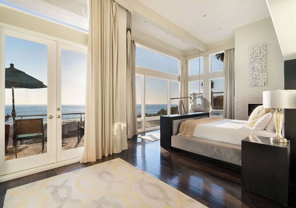 Primary bedroom with Ocean Views, King sized bed, electronic blackout blinds, en-suite bathroom with steam shower, giant walk-in closet, private patio with table and chairs