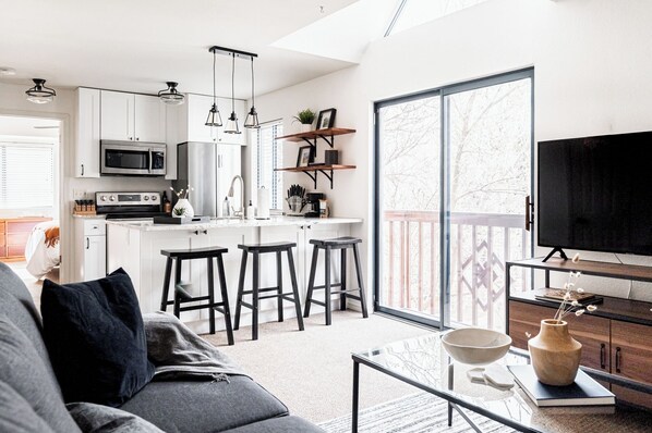 Full open living area with large sliding doors that let in plenty of light.