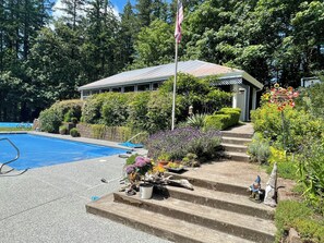 View of guest house bungalow and pool.