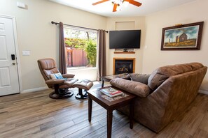 The living room offers plush seating and a big flatscreen perfect for unwinding.