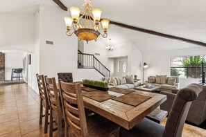Well decorated dining area with a bench and seating for eight.