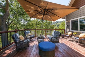 The expansive deck is nestled among black oaks that surround you in nature