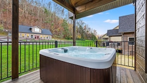 Hot tub on first floor deck for relaxing after a long day of games, hiking or shopping