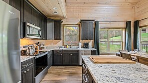 Full chefs kitchen with an island that is fully outfitted for your cooking needs