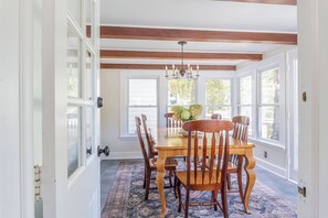 Exposed beams add to the charm of this cozy, sun-filled dining room
