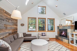 Relax with a good book or movie after a fun day on the mountain, lounging on the comfortable L-shaped couch and cozy chairs, with the warmth of a gas fireplace adding to the ambiance.