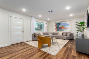 Large open living area featuring a Smart TV and designer furnishings.