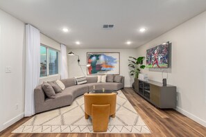 Large open living area featuring a Smart TV and designer furnishings.