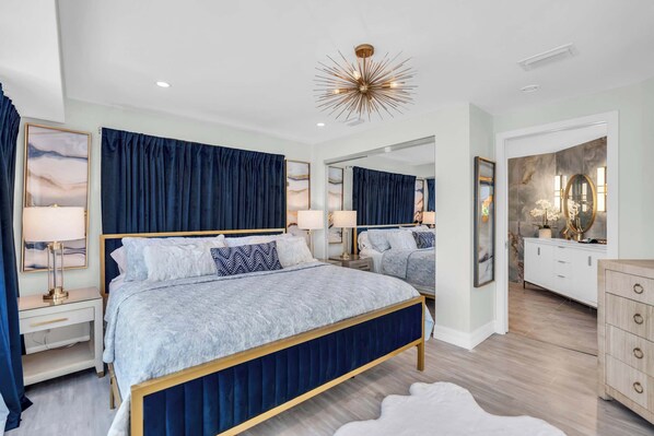 Primary bedroom #1 features a King bed and blue and gold accents throughout