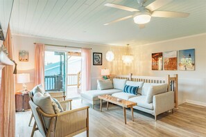 Living room on upper main level with sliders to the uppder decks.
