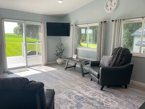 Living area with Roku TV and sliding door to outside, back deck