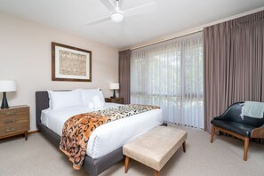 Enjoy the comfort of a queen bed with freshly laundered linen in this stylish bedroom.