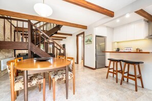 Wooden 4-seat dining table for cosy meals.