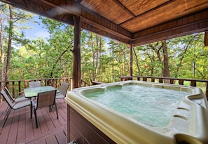 Unwind in the hot tub on the deck, surrounded by nature's tranquility—ideal for soaking under the stars after a day of adventure.
