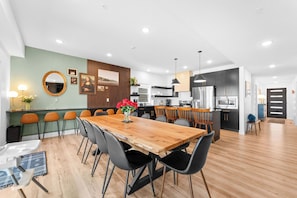 A custom live-edge dining table seats 10 + additional counter seating for all to gather together in the modern kitchen
