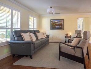 Front living room with electric reclining couch and two recliners. 