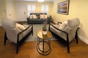 Front living room with electric reclining couch and two recliners. 